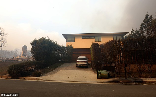 His home was surrounded by menacing smoke and dark skies, but even the trees and shrubs surrounding his home appeared largely untouched by the flames.