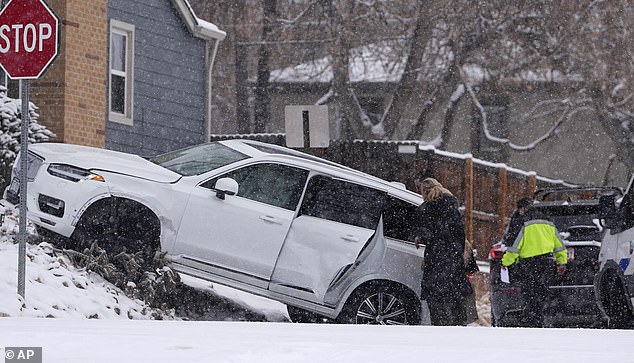 Another winter storm has battered the intermountain West this week. Motorists in Denver, Colorado investigate damage to a commercial vehicle after a storm-related crash