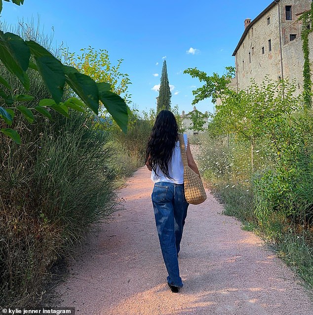 Kylie pictured herself strolling through Italy during the romantic trip, wearing jeans and a white flowing top