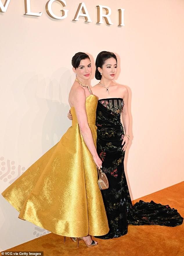 Anne – clutching a heart-shaped clutch – is a global brand ambassador for the Italian luxury fashion house, as is The Tale of Rose actress Yifei Liu (R)