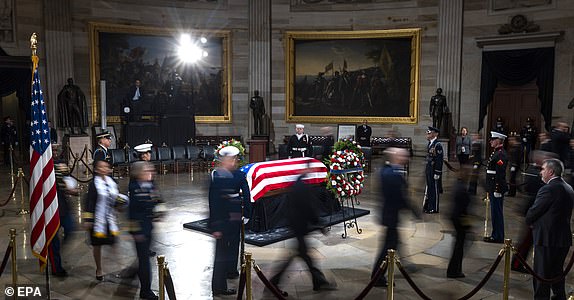 epaselect epa11812181 People stream past former President Jimmy Carter's casket in the U.S. Capitol Rotunda where he will lie in state for two days ahead of his funeral on January 9 in Washington, DC, U.S., January 7, 2025. Carter, the 39th American president died on December 29, 2024 at the age of 100 in his hometown of Plains, Georgia. EPA/JIM LO SCALZO