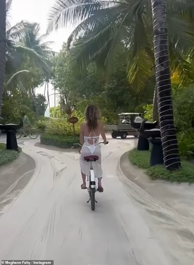 And donned a white bikini and a cover-up dress as he cycled around the resort