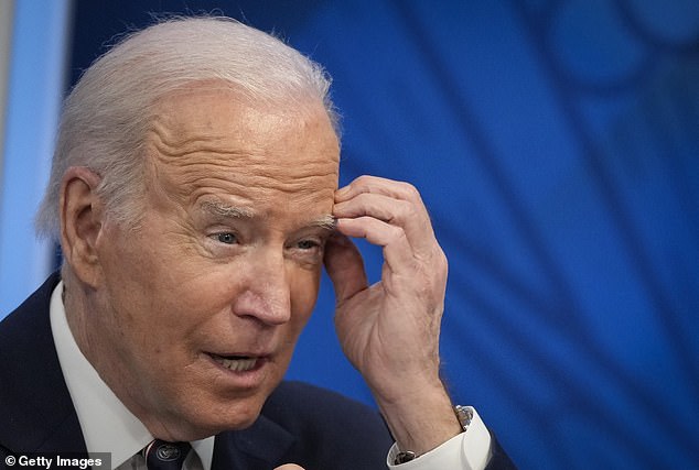 Joe Biden narrows his eyes and rubs his head as he participates in a virtual meeting on mineral supply chains and clean energy production at the South Court Auditorium of the White House complex on February 22, 2022 in Washington, DC