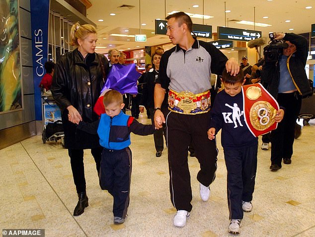 Nikita and Tim are pictured with their father Kostya and mother Natasha in 2002