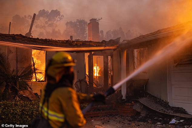 Firefighters battle flames from the Palisades Fire on January 8 in the Pacific Palisades community of Los Angeles