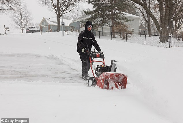 Winter Storm Cora comes just days after Winter Storm Blair brought heavy snow and ice to the Ohio Valley and Mid-Atlantic. The photo shows a man moving snow in Shawnee, Kansas on January 5