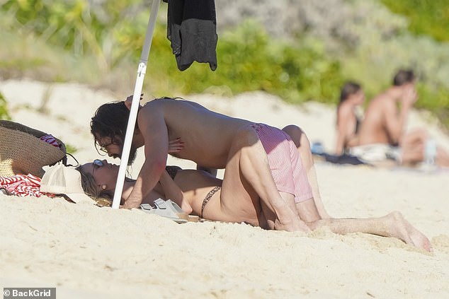 The pair were all over each other as they relaxed on the beach