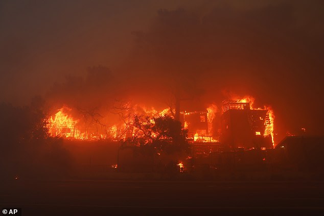 The Palisades Fire burns a building in the Pacific Palisades neighborhood of Los Angeles