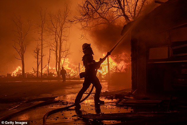 Firefighters battle the Eaton Fire in high winds as many homes burn on January 7, 2025 in Pasadena