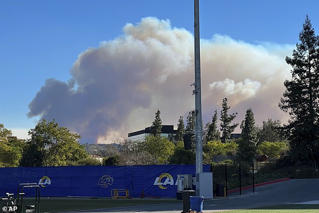 Smoke from a wildfire rises over the Los Angeles Rams NFL football training facility