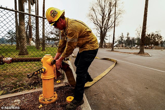 Quiñones said the water tanks, which help fill the fire hydrants, were all empty by 3 a.m. local time on Wednesday. (Image: A firefighter removes a hose from a fire hydrant after running out of water)