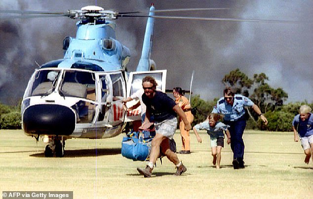 Residents of the hamlet of Bundeena, 40 kilometers south of Sydney, bordering the Royal National Park, are evacuated on January 7, 1994