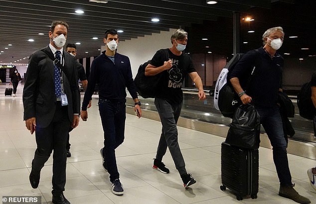 The 24-time Grand Slam champion is pictured, second from left, being escorted to his flight after the Australian Federal Court upheld a decision to revoke his visa in 2022.