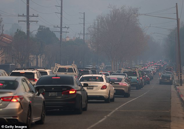 The family is among nearly 180,000 evacuees forced to leave their homes as at least five fires continue to burn unchecked; residents photographed as they evacuated ahead of the Kenneth Fire on January 9, 2025 in Calabasas