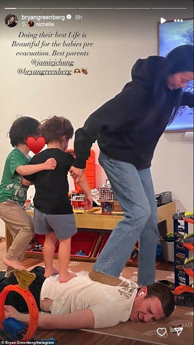 Greenberg reposted his girlfriend Nichelle Hines' Instastory of him and Jamie distracting their three-year-old twin sons before the terrifying evacuation