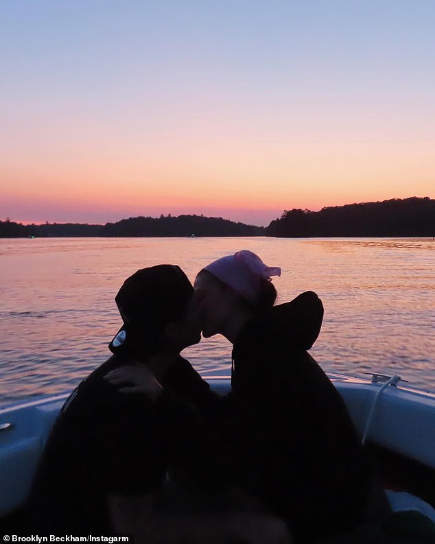 In another shot, the couple were seen kissing as they sat together in the front of a boat during a sunset trip to the sea