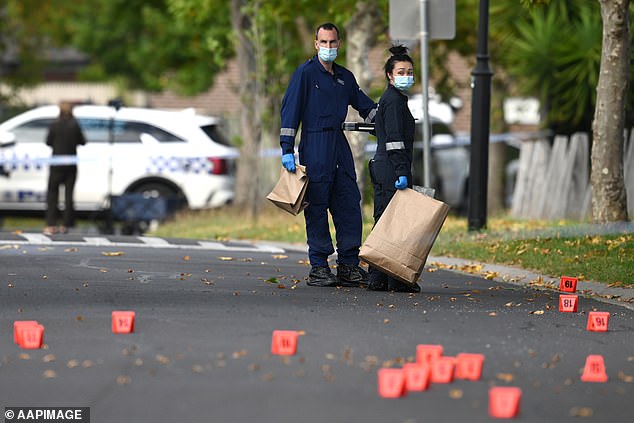 Photos showed the crime scene (pictured) littered with bullet casings over a wide area as detectives examined the crime scene Friday morning