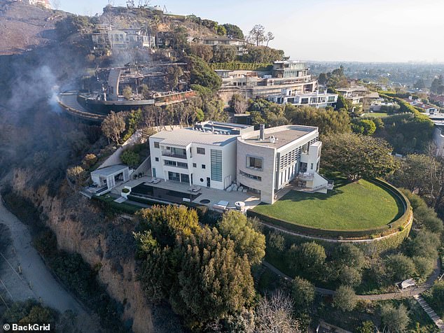 The Pacific Palisades mansion (pictured), which the couple bought in 2010, narrowly avoided the raging LA wildfire that has caused untold damage to the celebrity's beloved enclave.