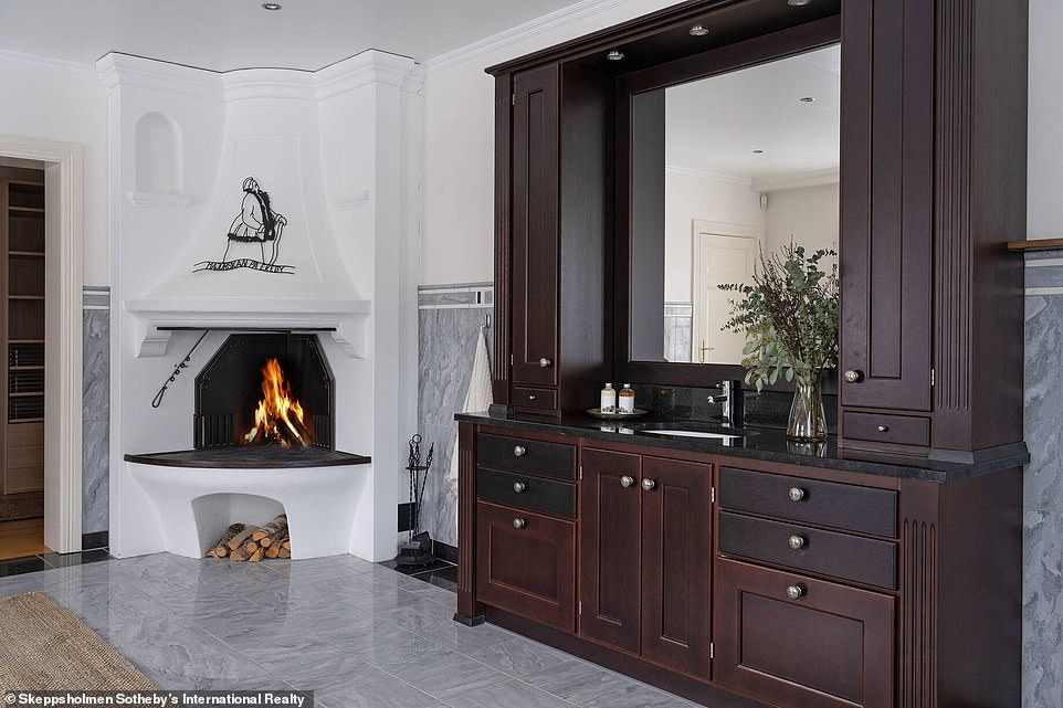 The house is complete with cozy wood-burning fireplaces and stylish marble and white details