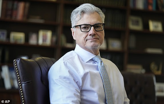 FILE - Judge Juan M. Merchan poses in his chambers in New York, March 14, 2024. Manhattan prosecutors urge the judge overseeing Donald Trump's criminal hush-money case to enforce a silence order that the Republican former president prohibits criticizing jurors and court staff, or members of the prosecution who convicted him. In court papers filed Friday, prosecutors with the Manhattan district attorney's office argued that parts of the silence order remained necessary given Trump's statements. "unique history of inflammatory and threatening public statements."  (AP Photo/Seth Wenig, file)