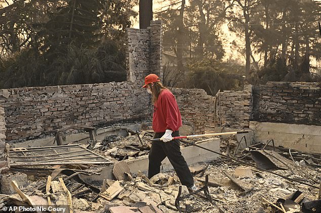 A man searches his destroyed home Thursday after the Eaton fire in Altadena, California