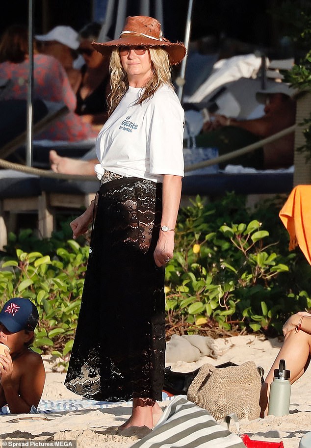 Penny arrived at the beach wearing a sheer black lace dress and white T-shirt