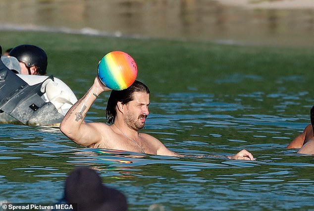 Liam showed off his competitive side as he tossed around a beach ball