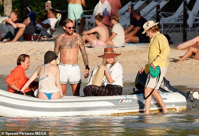 Rod cut a cheerful figure as he jumped into a dinghy