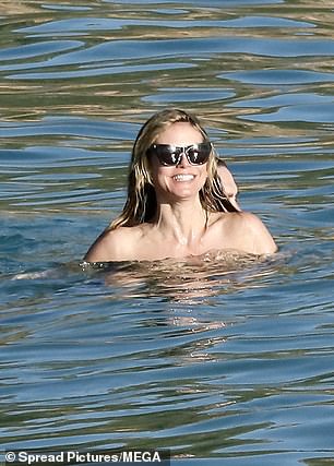 Heidi beamed from ear to ear as Tom hugged her in the ocean