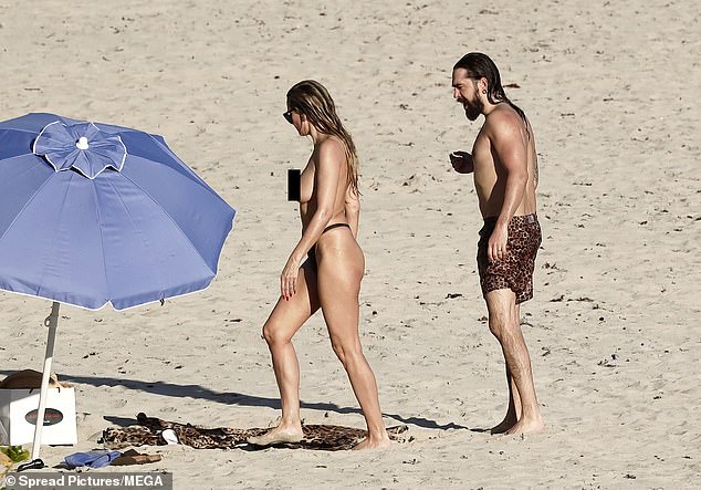 The lovebirds returned to their spot on the beach after their dip in the ocean