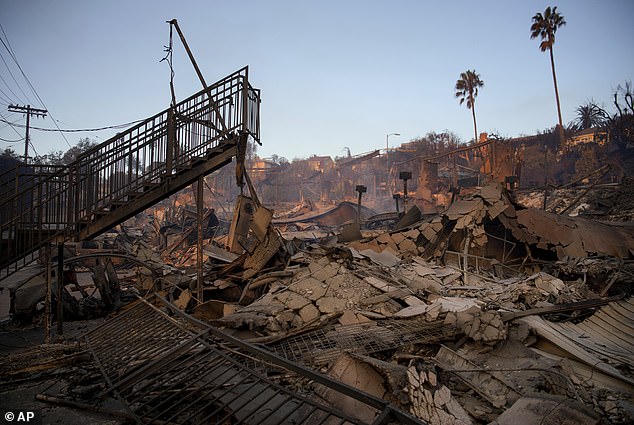 A staircase remains partially standing in a building in the aftermath of the Palisades fire in the Pacific Palisades neighborhood of Los Angeles, Friday, January 10, 2025