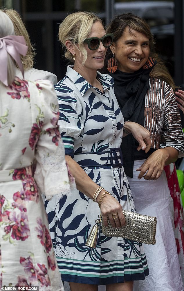 The daughter of Princess Anne and Captain Mark Phillips, adorned with delicate gold jewelry, including a bracelet and small earrings, and oversized sunglasses