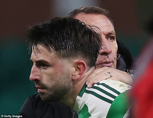 Brendan Rodgers comforts Greg Taylor after Celtic fans chant Tierney's name