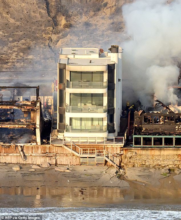 The three-story house looks almost pristine after the fires destroyed everything around it