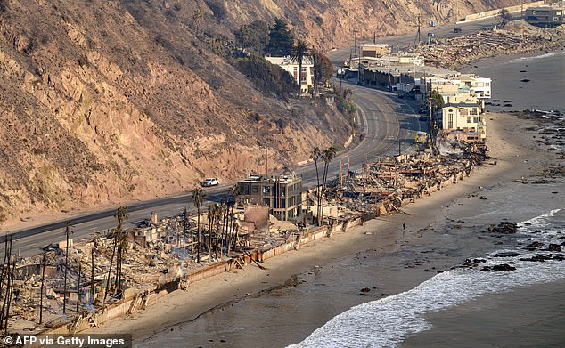 This aerial view taken from a helicopter shows burned homes during the Palisades fire in the Malibu area of ​​Los Angeles County, California