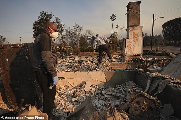 Kenneth Snowden, left, looks at the damage to his fire-damaged property after the Eaton fire with his brother Ronnie