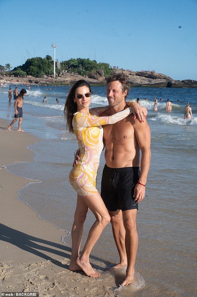 The couple posed for a cute photo on the beach