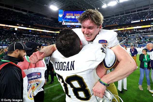 Notre Dame kicker Mitch Jeter is lifted by teammate Pat Coogan after the game-winning field goal