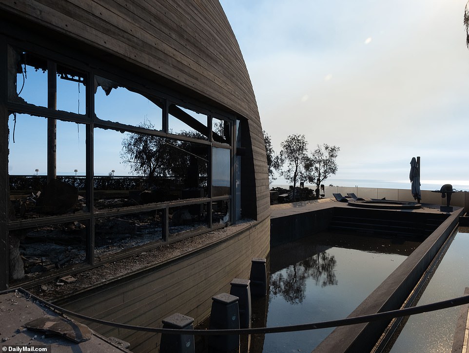 The outdoor pool, once the centerpiece of the garden, is now a scorched wooden pit filled with murky black water