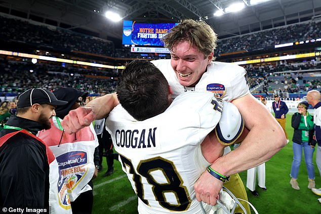 Mitch Jeter #98 of the Notre Dame Fighting Irish celebrates with Pat Coogan #78 after defeating the Penn State Nittany Lions 27-24 in the Capital One Orange Bowl