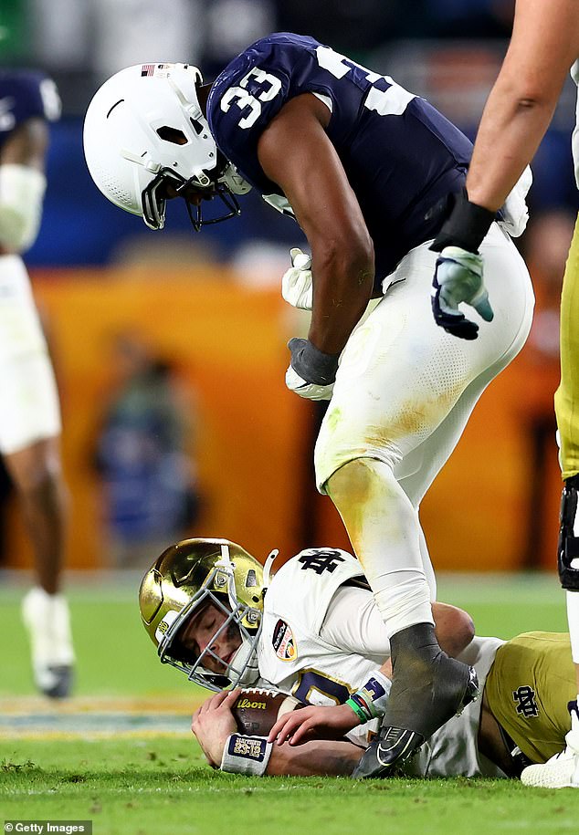 Dani Dennis-Sutton #33 of the Penn State Nittany Lions reacts after tackling Riley Leonard #13 of the Notre Dame Fighting Irish during the third quarter