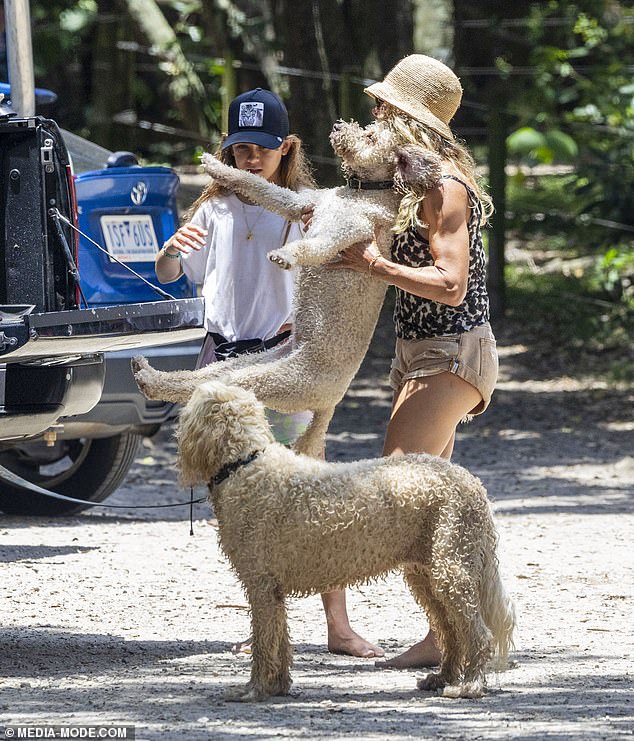 At one point, Elsa was seen sweetly carrying one of their beloved dogs as she helped them climb into the car