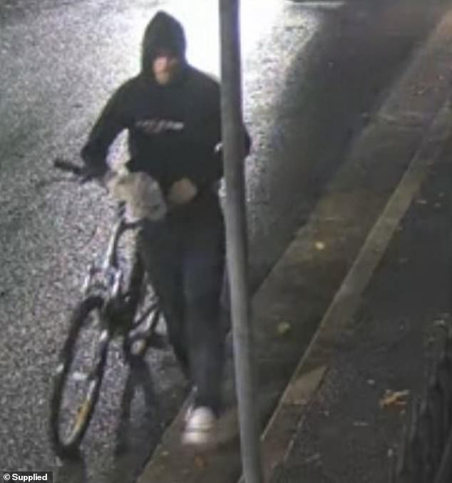 A man was seen pushing a mountain bike down the street (pictured)