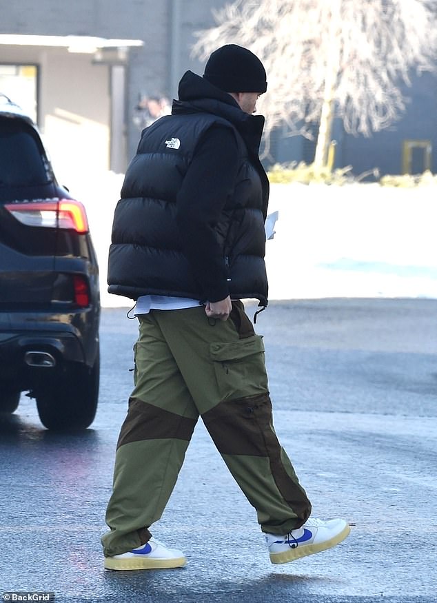 For his latest outing, Max kept his look casual with a black North Face vest over a black sweater, paired with khaki green cargo pants