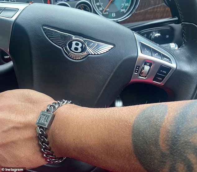 Opel Khan is no stranger to designer clothes and cars (pictured) wearing a Fendi bracelet behind the wheel of a Bentley