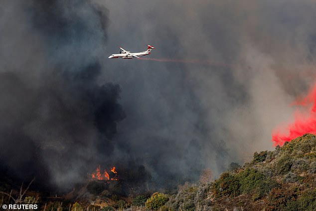 Firefighters and helicopters have also been seen circling the area, creating huge water drops as the 22,660-hectare fire continued to spread.