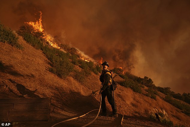 A firefighter is battling the Palisades Fire in Mandeville Canyon today