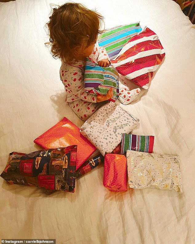 Romy pictured surrounded by a pile of presents as she celebrated her first birthday on December 9, 2022