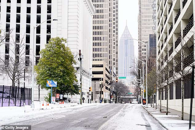 Snow blanketed parts of Atlanta after a storm on Friday as streets were largely deserted