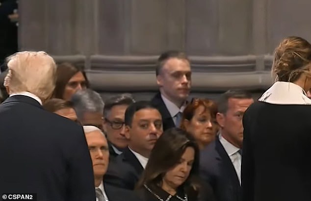 From an alternate angle, Pence can be seen looking at Trump as wife Karen Pence holds her face forward while looking down as Trump enters